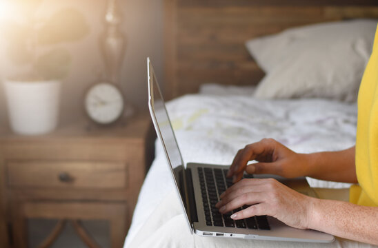 Woman In Yellow Sweater Working On Laptop Computer