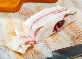 Appetizer sliced salted pork bacon at wooden background, nobody