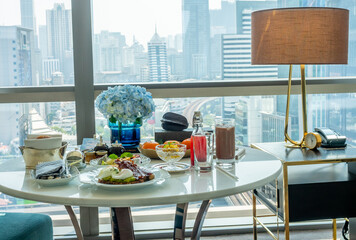 Breakfast set, fried egg, bacon, cereal, milk and pastry on elegant ceramic dish, served in luxury hotel