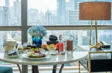 Breakfast set, fried egg, bacon, cereal, milk and pastry on elegant ceramic dish, served in luxury hotel