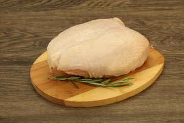 Raw whole chicken breast with skin