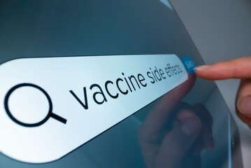 Close-up view of searching information about COVID vaccine side effects on the internet, shot with...
