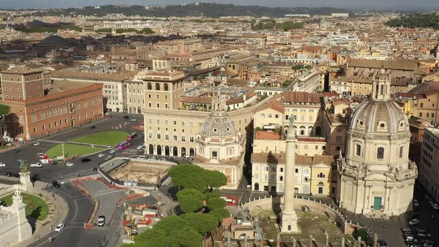 Aerial view of the Trajan's Forum (Foro di Traiano) with the ruins of ancient buildings in the center city of Rome, Italy. Famous tourist attraction in Roma, Italia seen from drone flying in the sky