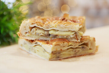 Chicken and potato pie on the dining table. The food is ready to eat. Puff pastry. kitchen utensils for cooking