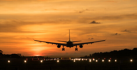 Fototapeta na wymiar Silhouette Airplane will take-off at an airport during sunset sky