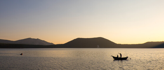 Fishing boat on a lake at sunset, Newberry Caldera National Monument, near Bend, Oregon, USA
