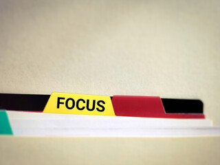 Inspirational and Motivational Concept - FOCUS sign on yellow mark surface background. Stock photo.