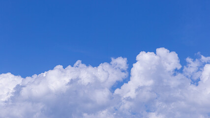 Naklejka na ściany i meble Blue sky background with tiny clouds for design