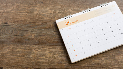 Close up the calendar on the brown table in planning ideas.	