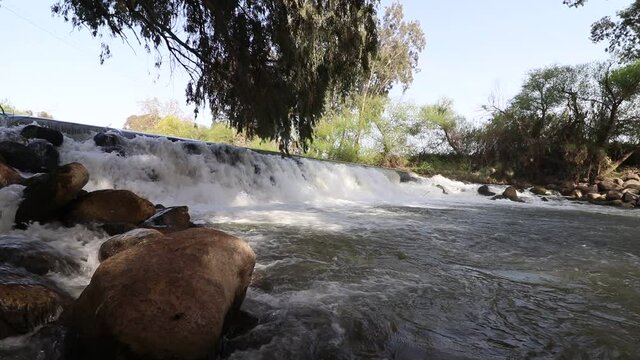 The dam on the Jordan River in the village of Blum, a waterfall that passes over the dam to the historic Jordan