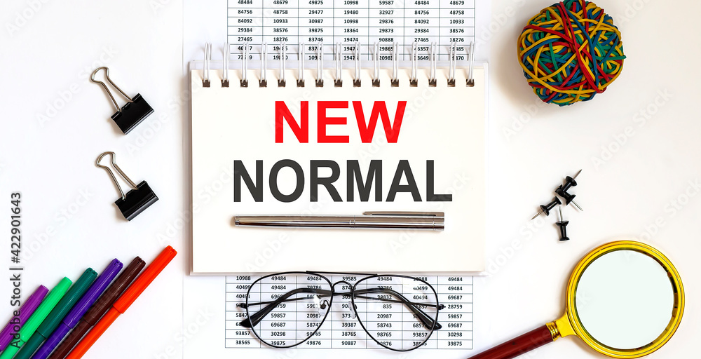 Poster notebook with text new normal on table on the chart