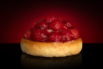 Fresh fruit pie tart with with raspberry on dark background