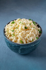 Rice in a bowl on a dark blue background