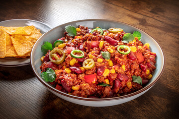 Chili con carne in a bowl with nachos