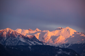 Snow covered swiss mountains in the evening light