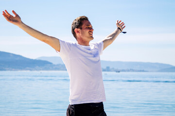happy and carefree man enjoying the feeling of freedom on the beach