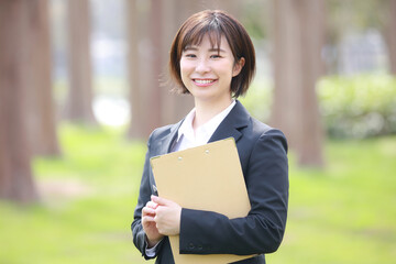 Fototapeta premium バインダーを持つ女性社員