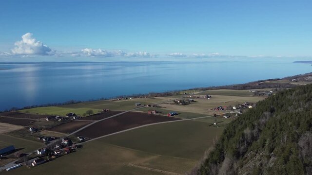Drone flight over forest jonkoping with view on lake 