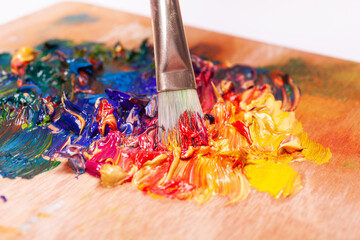 Paint brush mixed different color oil paints. colorful acrylic. modern art concept