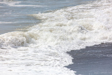 Fototapeta premium Wave on the seashore as a background.