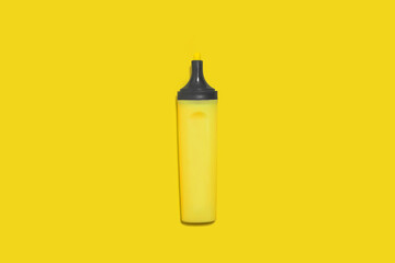 yellow office marker without a cap on yellow back