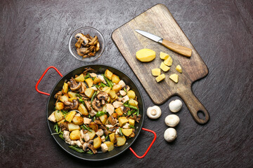 Frying pan with tasty vegetables and chicken on dark background