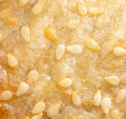 Sesame seeds on a crust of bread as a background.