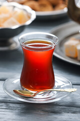Cup with hot Turkish tea on wooden background