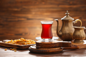 Cup with hot Turkish tea on wooden background