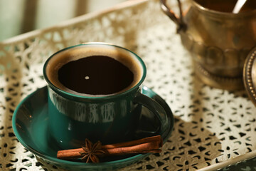 Cup of hot coffee on light background