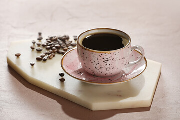 Cup of hot coffee on color background