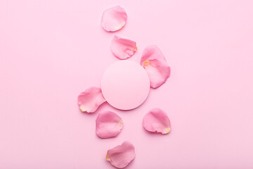Beautiful pink rose petals and blank card on color background