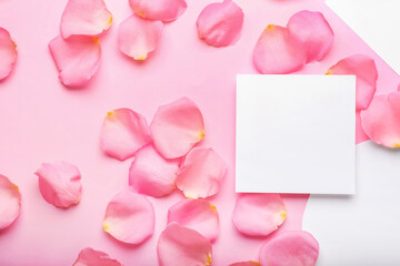 Beautiful pink rose petals and blank cards on color background