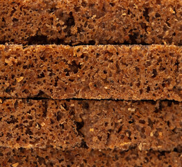 Black rye bread as background.