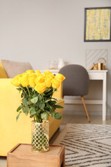 Vase with beautiful yellow roses in interior of room