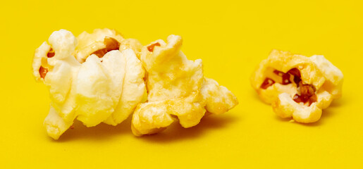 Close-up of popcorn on a yellow background.