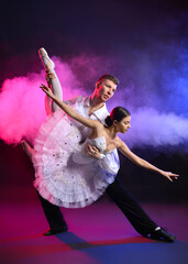 Young ballet dancers on color background