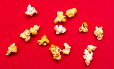 Close-up of popcorn on a red background.