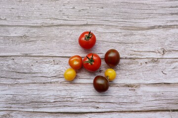 colorful tomatoes on a white wooden table