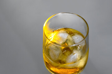 White Negroni cocktail  on grey background.