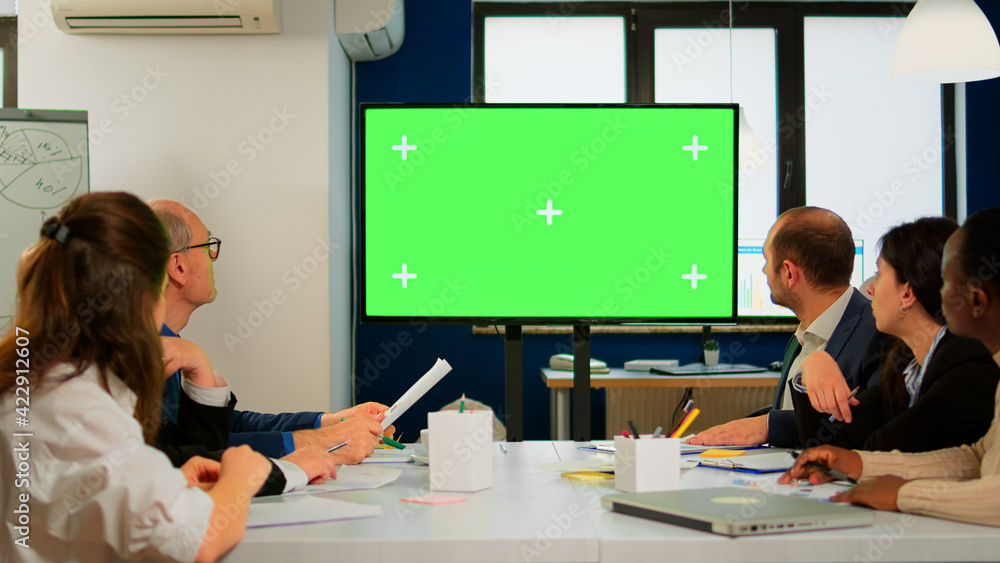 Poster tv green screen mockup ready for presentation placed in front of desk while business people working 
