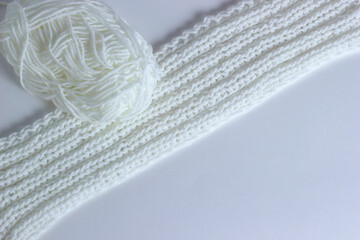 White knitted textured background with a pattern, acrylic and cotton knit fabric, closeup. Copy spase. White background