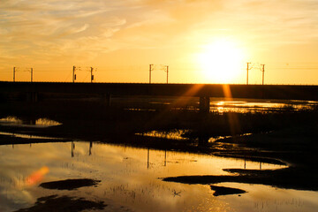Idyllic sunset with yellow and orange colors and a lake in the background