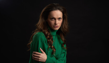 Pretty woman with long brown hair over black background