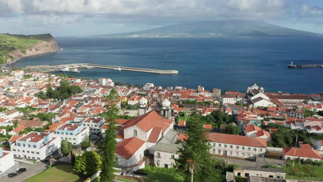 Aerial view of old town of Horta, Faial Island, Azores, Portugal, Europe. Drone shot of Porto Pim Bay and mount Guia in distance. City landmark with atlantic ocean, 4k footage