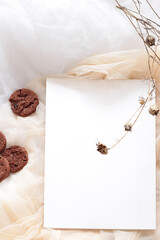 white paper sheet template with chocolate homemade cookies and dry flowers