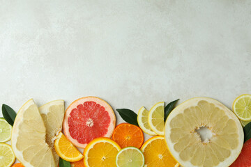 Ripe citrus slices on white textured background