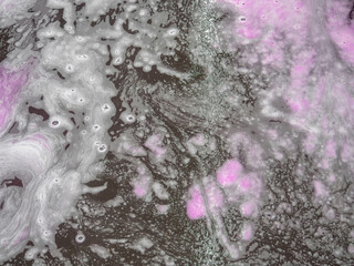 Colorful white bath foam with bubbles on the ground. Effect of space and galaxy. Abstract art....