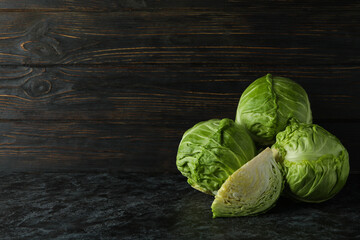 Fresh green cabbage on black smoky table