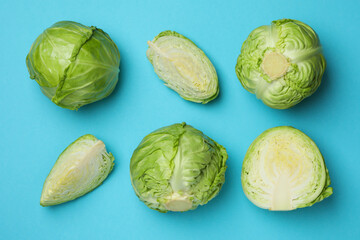 Fresh green cabbage on blue background, top view